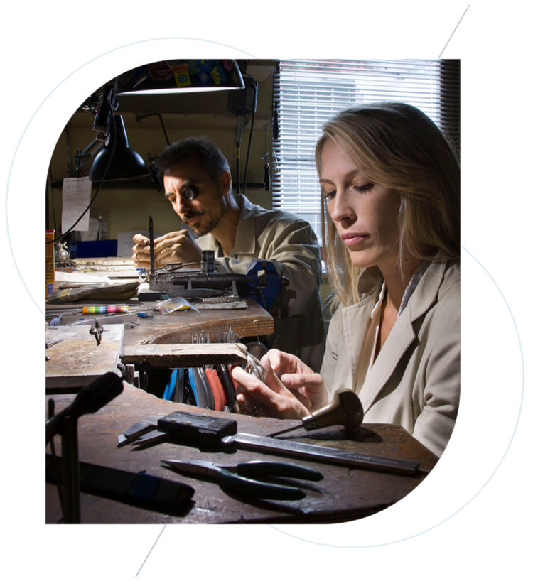 Two people working together in a workshop setting.