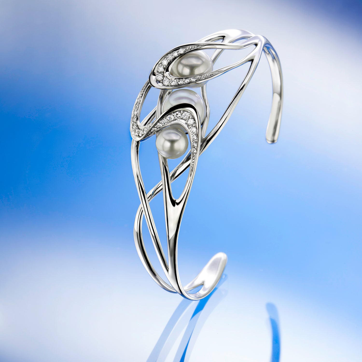 Silver bracelet with pearls on a beige background