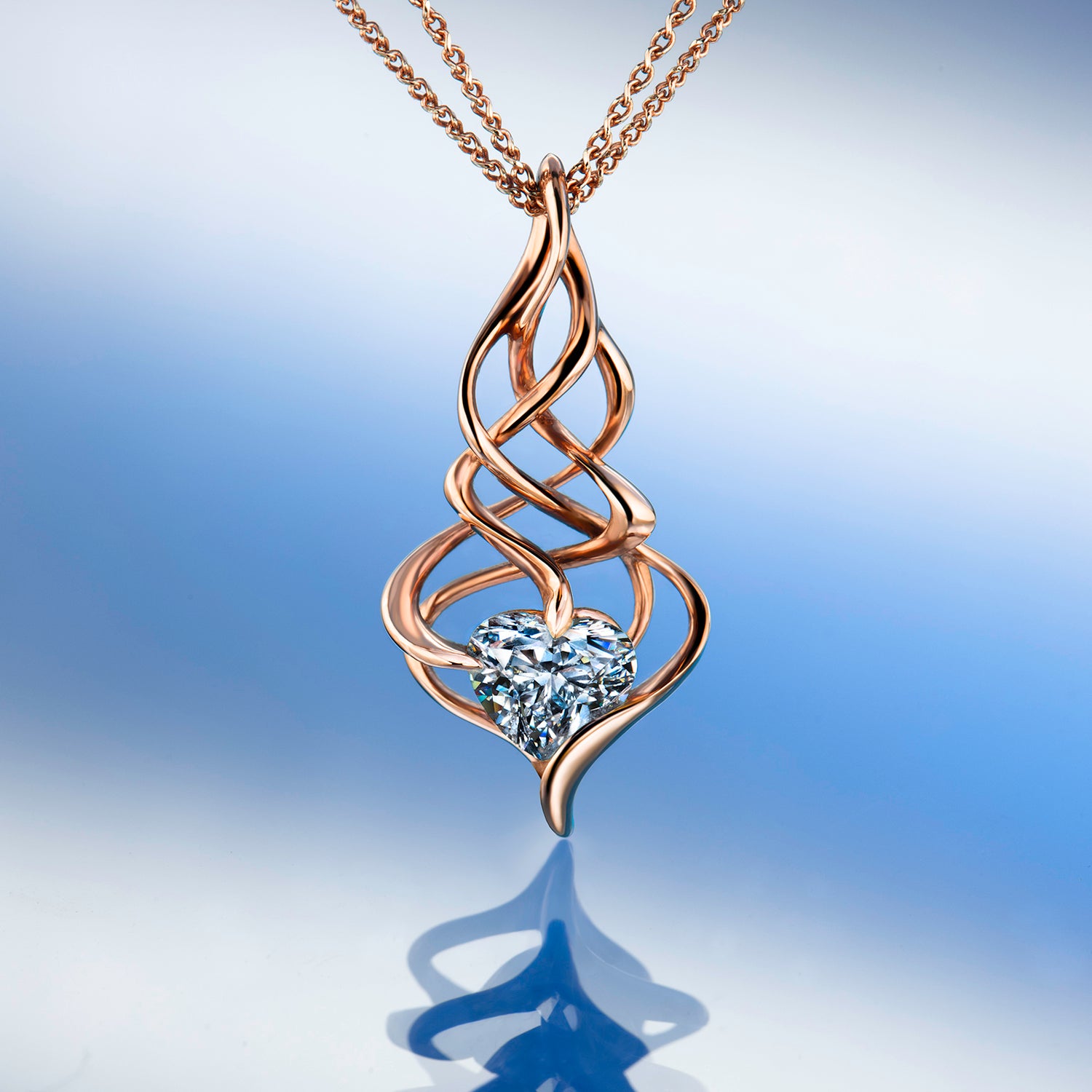 Gold pendant with a heart-shaped diamond on a beige background